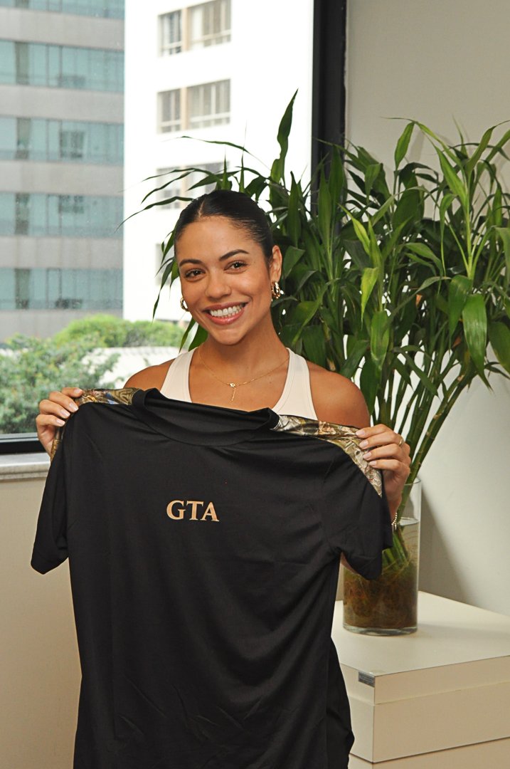 Mulher sorrindo com camiseta GTA